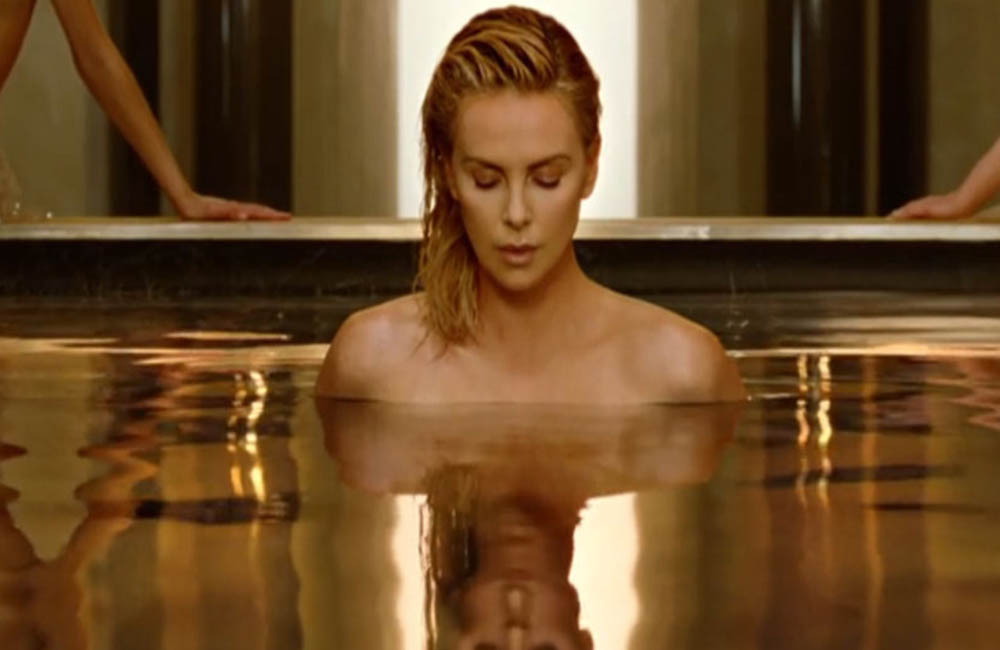 Charlize Theron strips for new Dior fragrance ad