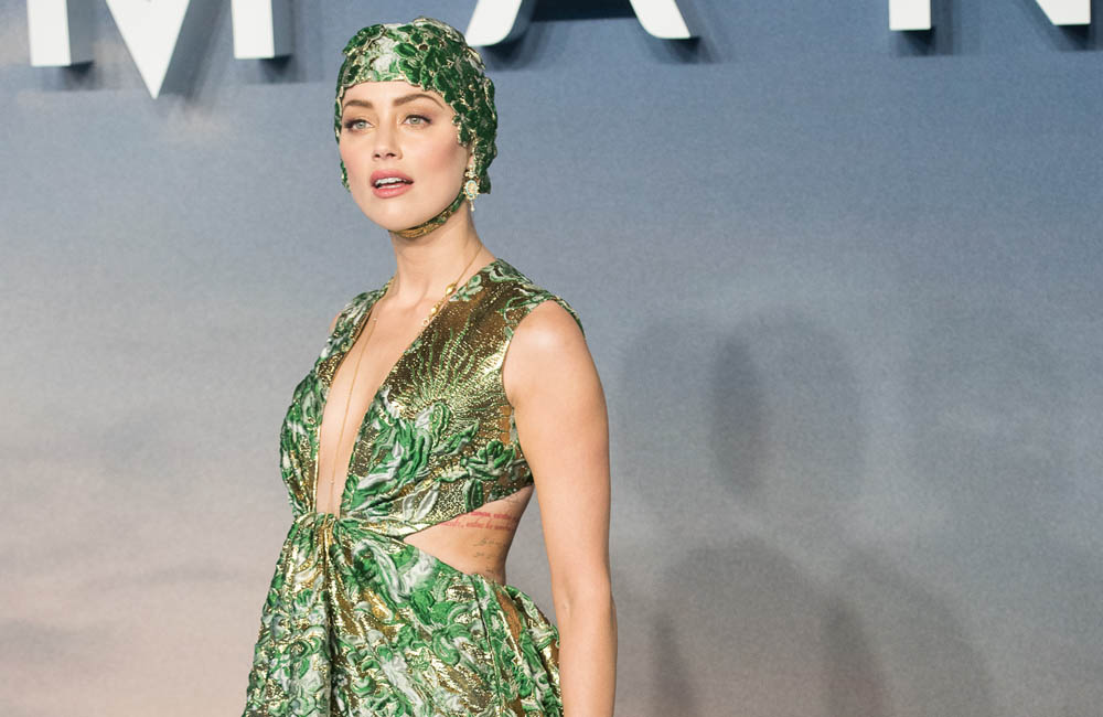 Amber Heard wears swimming cap to the Aquaman premiere