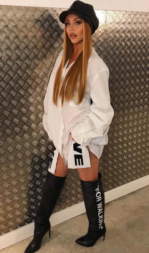 Jesy poses in cap white shirt and knee high monochrome outfit