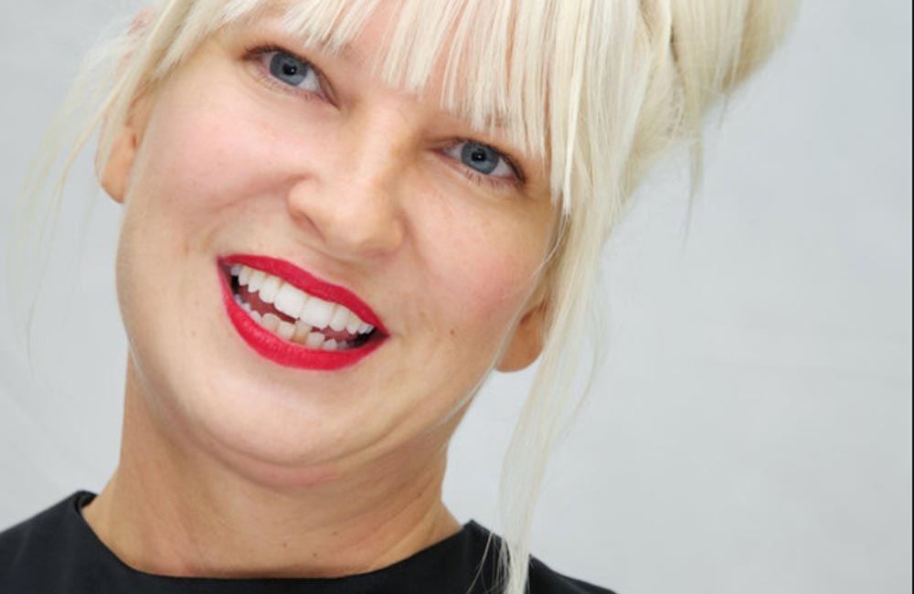 Sia Reveals Her Face After Wind Blows Her Wig